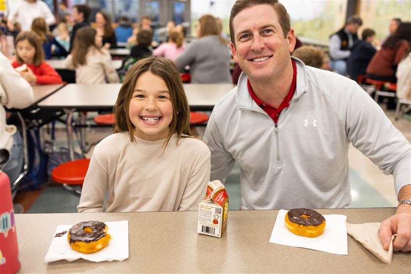 Students and their families enjoy donuts
